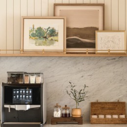 a coffee machine and neutral colored decor